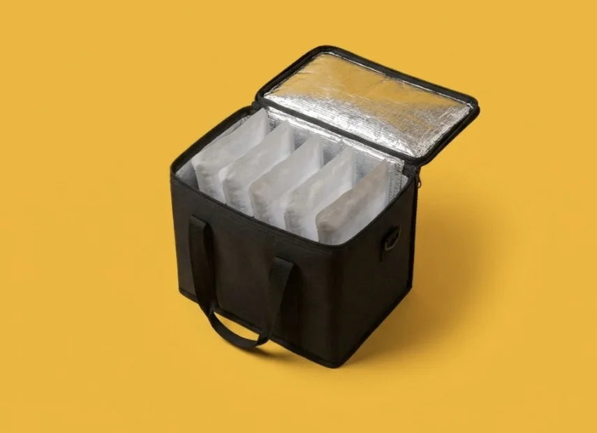 An insulated delivery bag packed with Wagbowl pouches